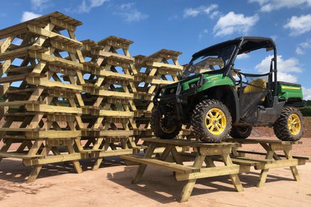 Stacked picnic tables ready for dispatch